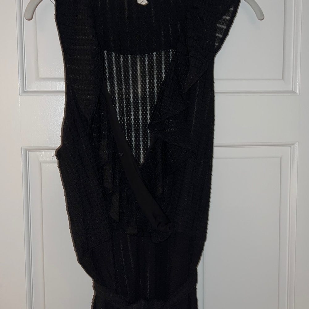 Sleeveless black dress. V neck. Lined to the mid thigh but full length. Tie wrap
